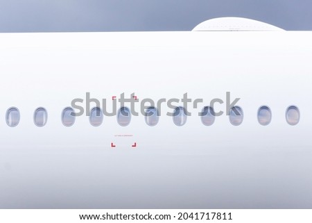 Airplane fuselage with portholes and satellite internet module on the roof wi fi Royalty-Free Stock Photo #2041717811
