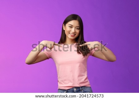 Active energized friendly tender asian stylish girl introduce herself, pointing chest proudly, smiling boastful, describe own achievements, bragging accomplishments, stand pleased purple background Royalty-Free Stock Photo #2041724573
