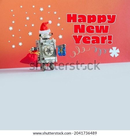 Festive New Year Christmas card template. A toy robot Santa Claus, red hat, large bag of gifts wishes a Happy New Year. Snowflakes on red orange background. Copy space for text on gray.