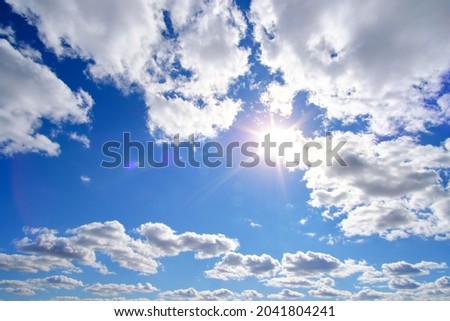 Bright, summer, sultry sun against background blue sky and white clouds Royalty-Free Stock Photo #2041804241