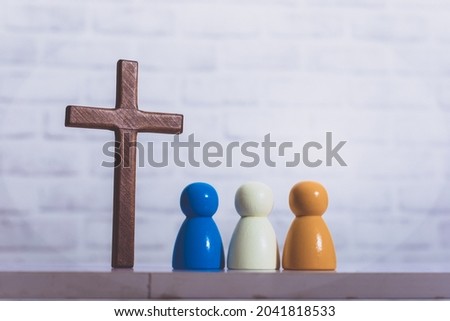Wooden figure with wooden christian cross