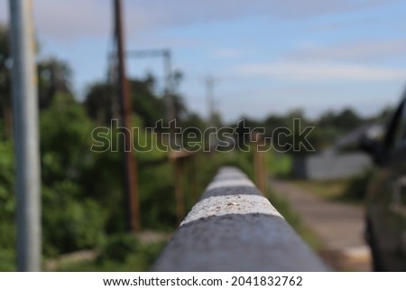 Photo of a Black and White stripe in a iron crash barrier