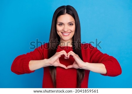 Portrait of attractive cheerful woman showing heart sign health care isolated over bright blue color background