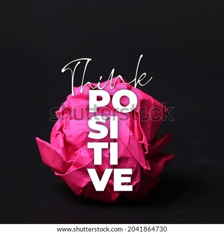 Motivational Quote Images. Inspirational Quote Background. Think Positive with pink crumpled paper ball. Dark Background.