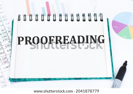 proofreading word on notepad on office desk, business concept