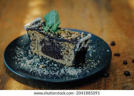 Brown and black bread with green leaf on blue ceramic plate