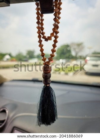 Muslim prayer beads hanging in the car Royalty-Free Stock Photo #2041886069