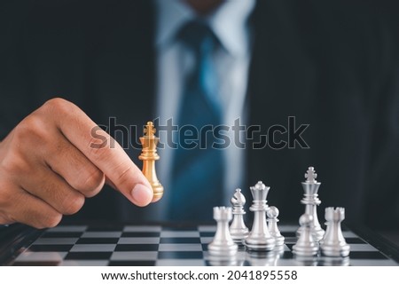 Businessman moves chess with hand.Strategic planning concept about mistakes topple the opposing team and analyze the development for the success of the organization.