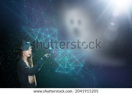 A girl dressed as a witch weaves a protective net from a ghost. Picture with a dark background for Halloween. Mystical production with magical elements