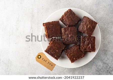 brownies  or pie with walnuts, on a plate, horizontally, top view Royalty-Free Stock Photo #2041922237