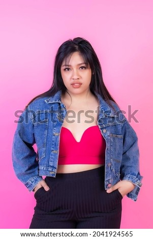 Portrait beautiful Asian fat women , fat girl , chubby, plump young woman posing on pink background , plus size fashion model body positive concept