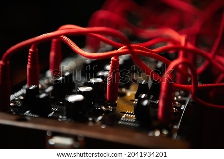 Analog synthesizer with audio cables. Professional modular synth device for electronic music production in sound recording studio Royalty-Free Stock Photo #2041934201