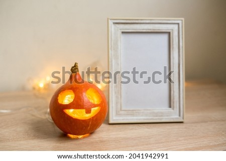Autumn minimal composition. Thanksgiving holiday concept. Photo frame, pumpkin on white background. Front view, copy space . High quality photo