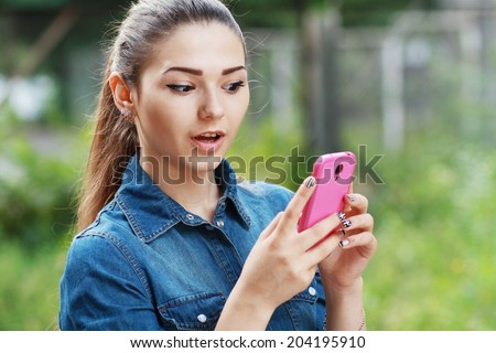anxcios young girl looking at phone seeing bad news or photos there with disgusting emotion on her face 