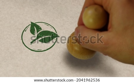 Green leaf eco friendly symbol stamp and stamping hand. Co2 neutral, ecology, environment, nature and climate concept.