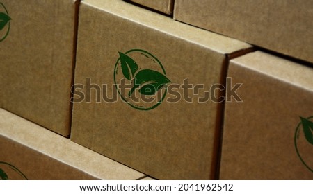 Green leaf eco friendly symbol stamp printed on cardboard box. Co2 neutral, ecology, environment, nature and climate concept.