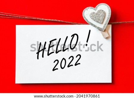 HELLO 2022. background with hearts and card. decorations on red background. concept new year