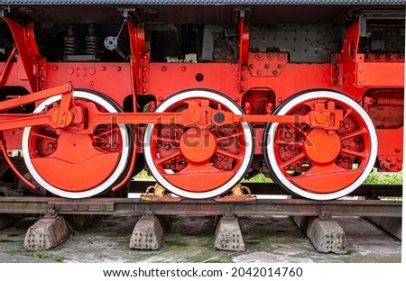 Red painted old steam locomotive wheels 