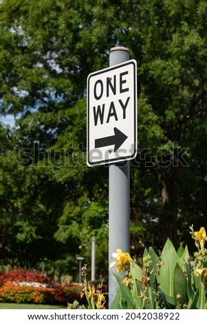 One way with an arrow black and white road sign with a shallow depth of field