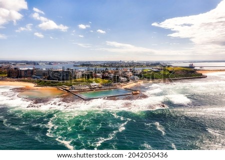 Aerial view from Pacific ocean towards Newcastle city waterfront around rock pools and beaches at delta of Hunter river. Royalty-Free Stock Photo #2042050436