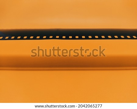 35mm negative film for photography isolated on orange background