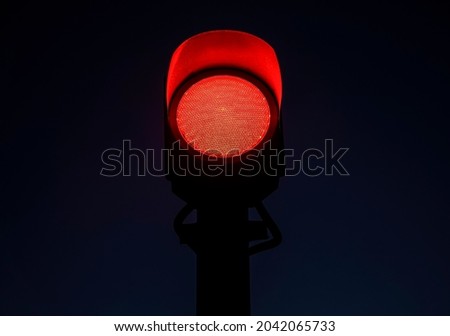 Red traffic light on the road in night city. dangerous signal stop crash driving highway,expressway; Blurred background of car dark fast truck surveillance security with semaphore. safety street Royalty-Free Stock Photo #2042065733