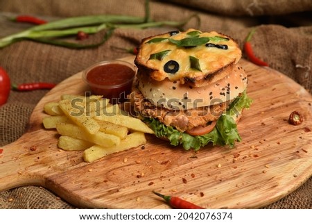 A hamburger (or burger for short) is a food, typically considered a sandwich, consisting of one or more cooked patties of ground meat, usually beef, placed inside a sliced bread roll or bun. 