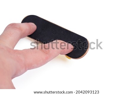 Isolated plays with a fingerboard. Man playing fingerboard on white background. clipping path.