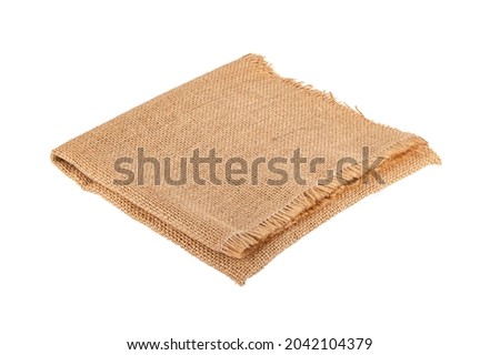 Folded burlap hessian sack isolated on white   background. Royalty-Free Stock Photo #2042104379