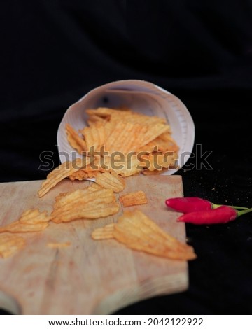 Baked potato chips. Snacks wrapped in sweet and spicy red spices add to the taste of potato chips. Crispy and savory potato chips for your snack. Chips mockup. Focus blur.