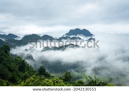 A beautiful view of mountain range with greenery forest and misty environment in the morning time. Relaxation with nature view, scenic photo seen. Royalty-Free Stock Photo #2042130551