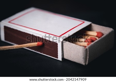 Match box with matchstick with dark black background. Light life, last hope, idea concept. 