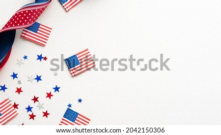 Columbus Day card, poster, background. Flat lay composition with United states decorations and ribbon on white background.