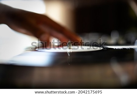 Vinyl record on turn table player. Hip hop dj play music on retro turntable device. Disk jokey mixing musical tracks on analog records. Download stock photo of professional disc jockey audio equipment