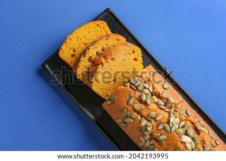 Tasty pumpkin pie on color background