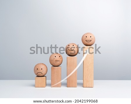 Satisfaction and business growth process and economic improvement concept. Emoticon, emotion faces wooden balls and wood cube blocks chart steps on white background with copy space, minimal style. Royalty-Free Stock Photo #2042199068