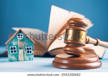 judge's hammer, book and house on the table