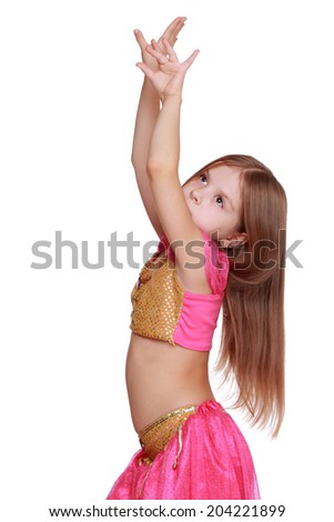 Studio image of pretty little girl dancing in the costume of the eastern beauty isolated over white background/Little arabic belly-dancer
