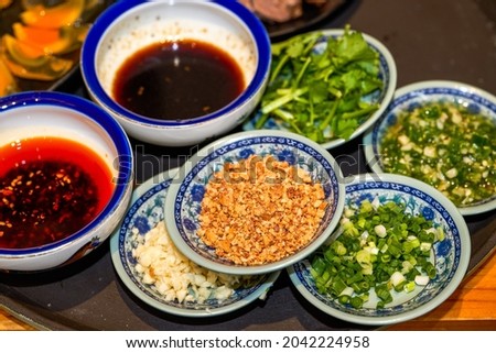 Various seasonings for hot pot, crushed peanuts, shallots, soy sauce, chili