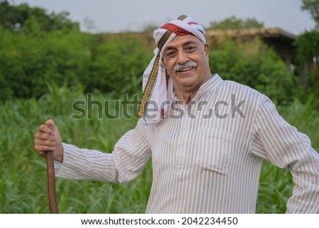 An old farmer is doing cultivation in their field