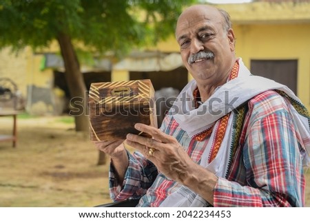 An old farmer is doing cultivation in their field