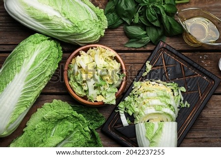 Fresh cut chinese cabbage on wooden background Royalty-Free Stock Photo #2042237255