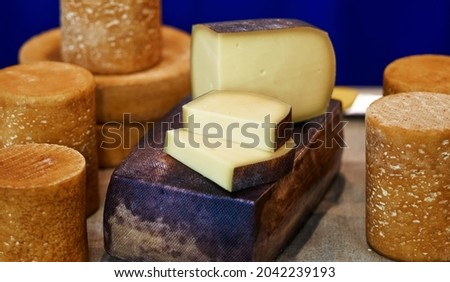 Large selection of cheeses on typical farmer market. Selective focus. High quality photo Royalty-Free Stock Photo #2042239193