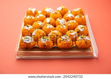 indian sweet motichoor laddoo or Bundi laddu made of gram flour very small balls or boondis which are deep fried and soaked in sugar syrup before making balls Royalty-Free Stock Photo #2042240732