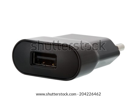 the USB charger for the smartphone and mobile devices of black color on a white background.