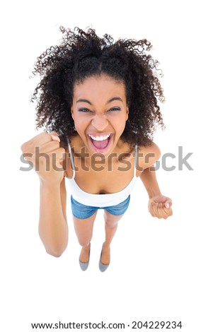 Pretty girl cheering at camera on white background