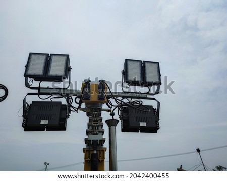 Portable led light tower. Construction site lighting stand with four spotlights.