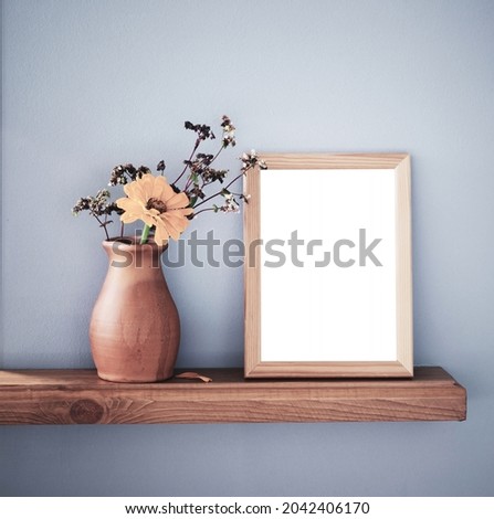 autumn flowers in rustic ceramic vase and isolated frame  on background gray wall