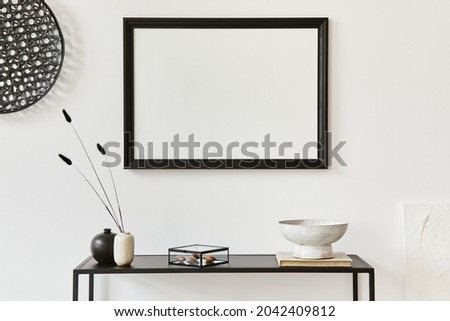 Minimalistic stylish composition of creative room interior design with mock up poster frame, metal shelf and personal accesories. Black and white concept. Template.