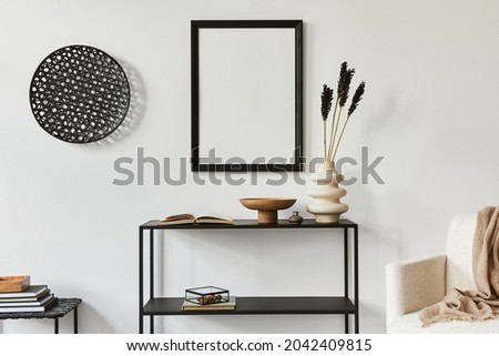 Minimalistic stylish composition of creative room interior design with mock up poster frame, metal shelf, armchair and personal accesories. Black and white concept. Template.